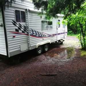 RV Parked on Lot with Puddle